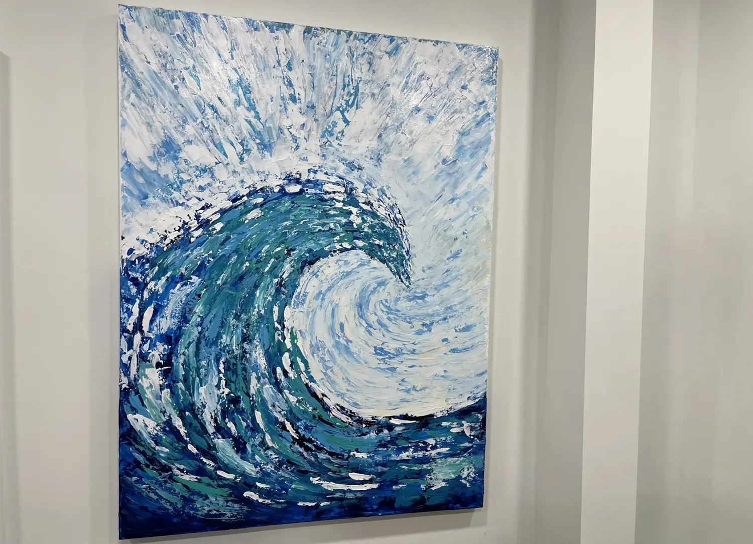 Large abstract painting of a swirling ocean wave in shades of blue, teal, and white, with textured brushstrokes creating movement and energy.